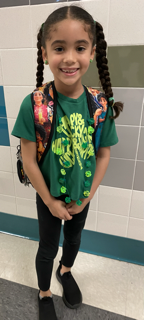 photo of student wearing green to celebrate.